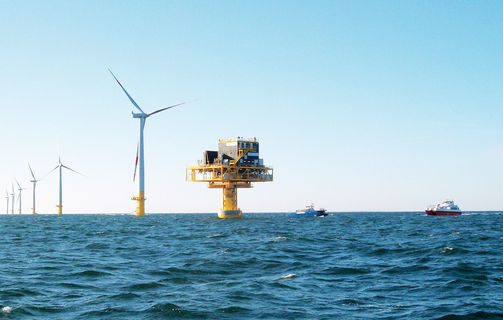 Triton Knoll offshore wind park with turbines and substation during sunny weather